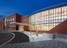 A picture of an office building with a glass window facade.