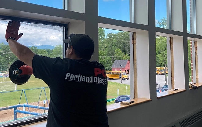 A Portland Glass technician cleaning newly installed glass.