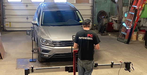 A Portland Glass employee performing an ADAS Windshield Calibration on a car.