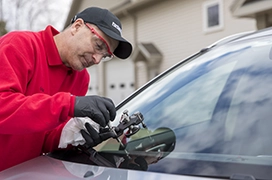 A Portland Glass technician working on a customer's car windshield.