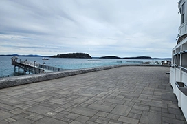 A picture of a glass railing overlooking a harbor.