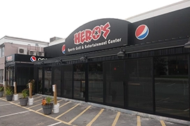 A picture of restaurant storefront with a glass door and windows.