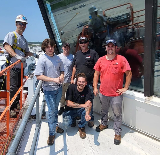 Portland Glass employees standing outside of commercial building with newly installed glass.