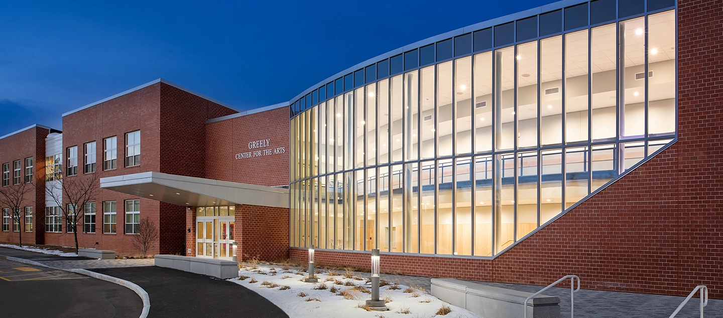 A picture of a commercial building with a large glass atrium.