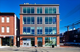 A picture of a storefront with newly installed glass doors and windows.