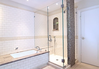 Corner Shower with Cut to Adjoining Bath with Chrome Hardware.