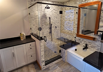 Glass Shower with Black Trim and Pivot Door.