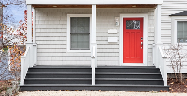 A picture of a red front door with glass panes.