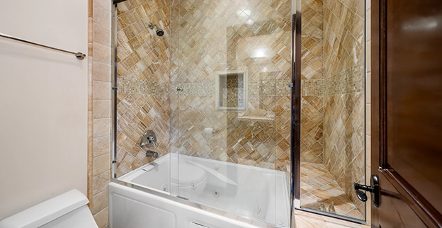 A picture of a framed custom glass shower enclosure.