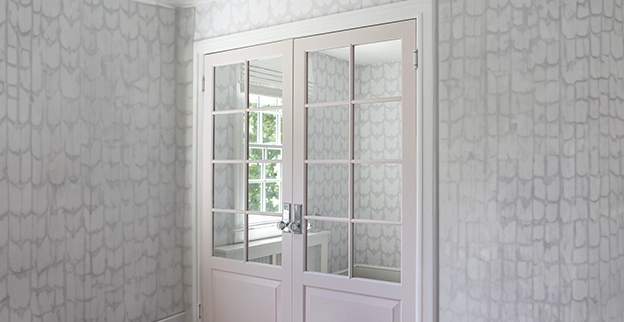 A picture of French doors with milled glass windowpanes.