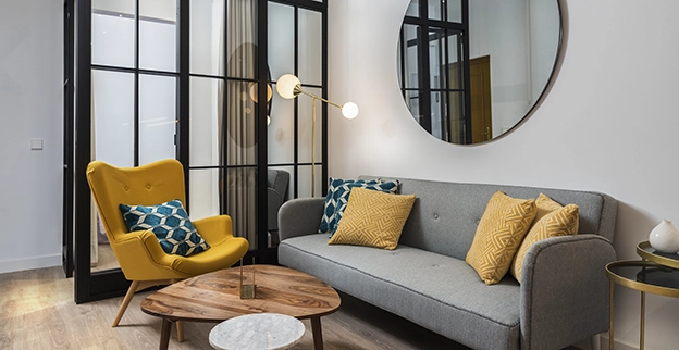 A picture of a glass wall in a family room next to a sofa.