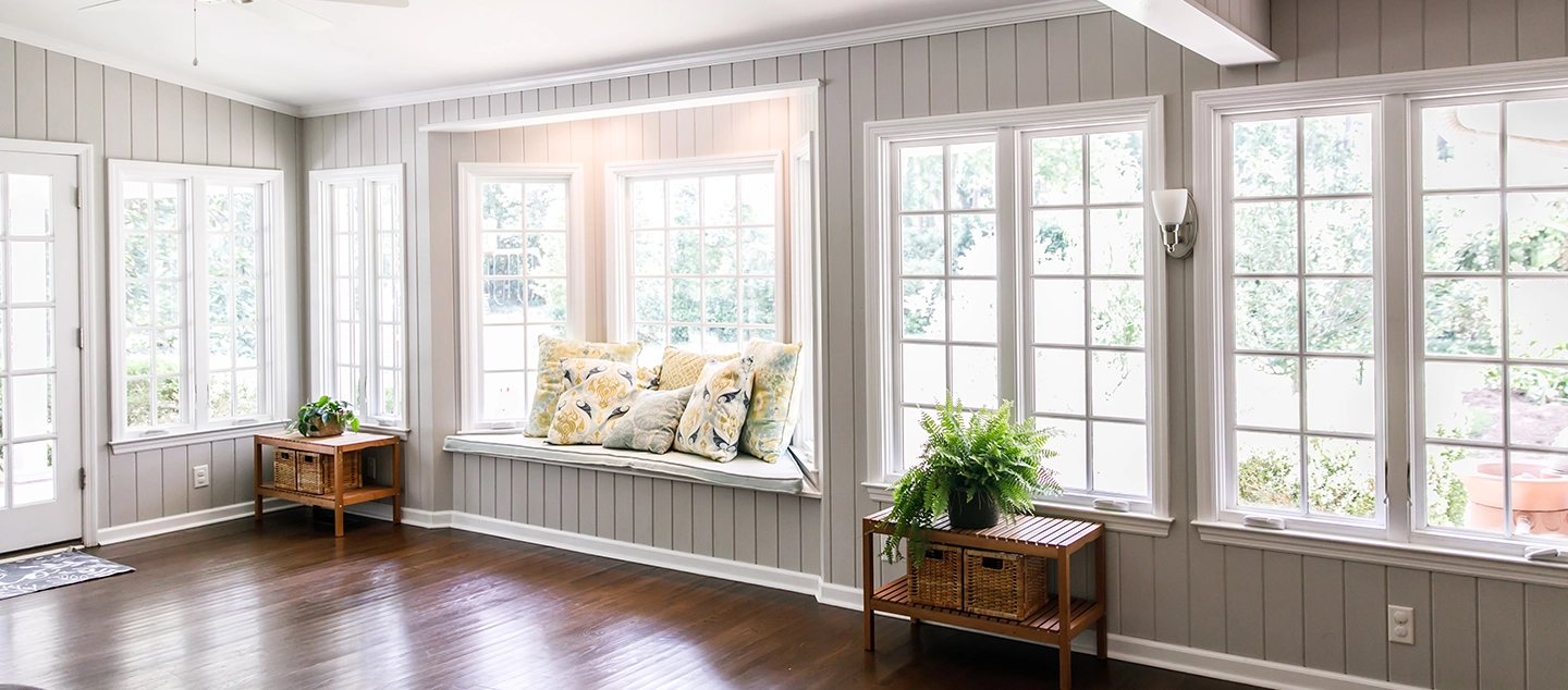 A picture of a living room naturally lit by windows.